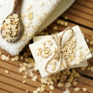A close-up of handmade oatmeal soap with twine on a wooden table.